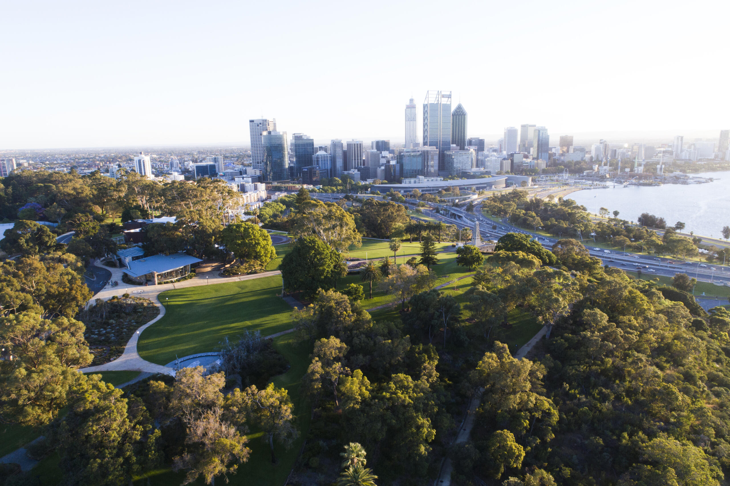 Aerial view of Kings Park and Botanical Garden with Perth City skyline in the background.
