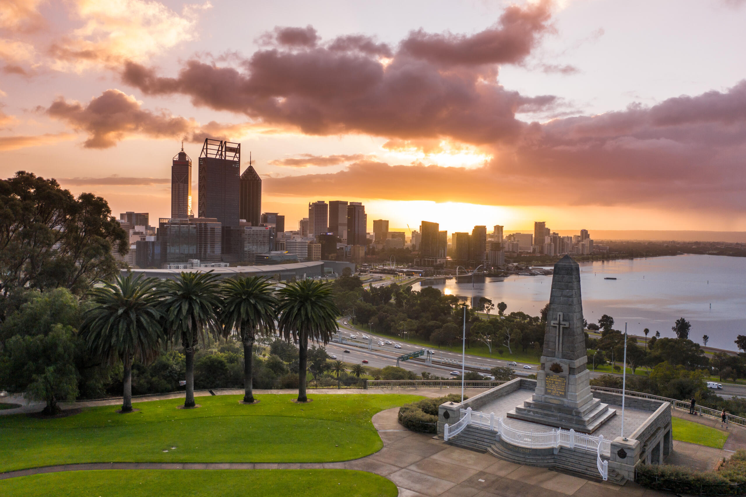 Aerial view of Kings Park and Botanic Garden at sunrise with the Perth Skyline in the background.